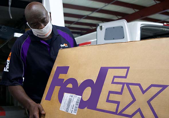 FedEx Worker moving FedEx box